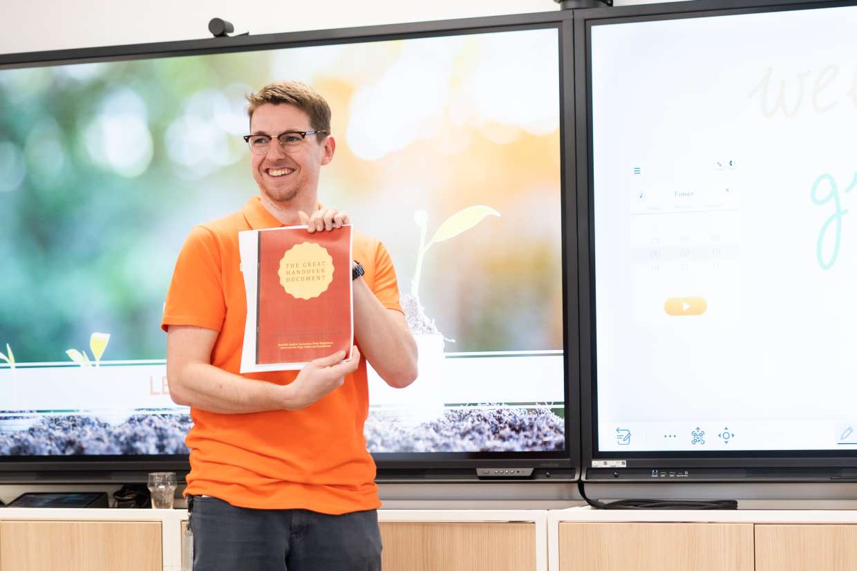 person holding a document saying "the great handover document"