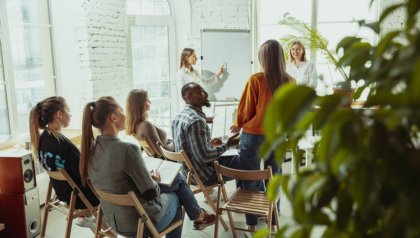female-caucasian-speaker-giving-presentation