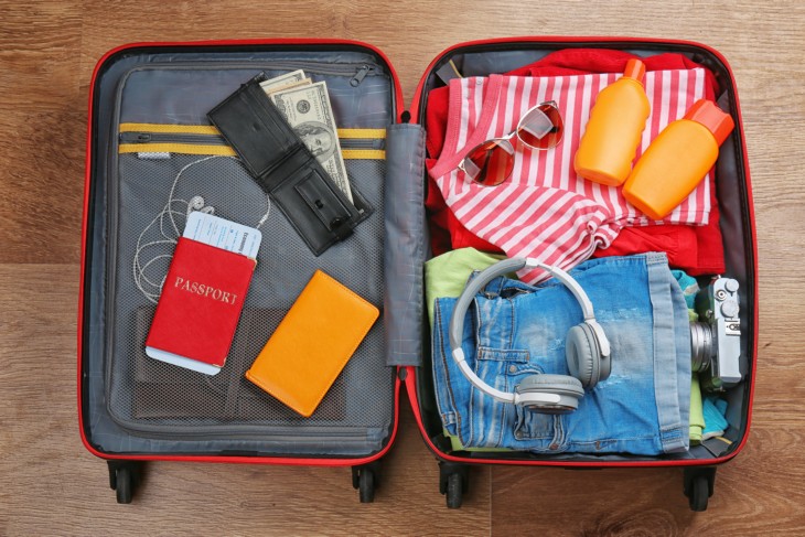 A suitcase filled with clothing, a passport and money.