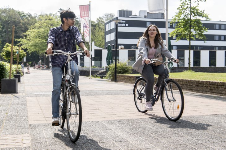 Students biking along the boulevard on campus.