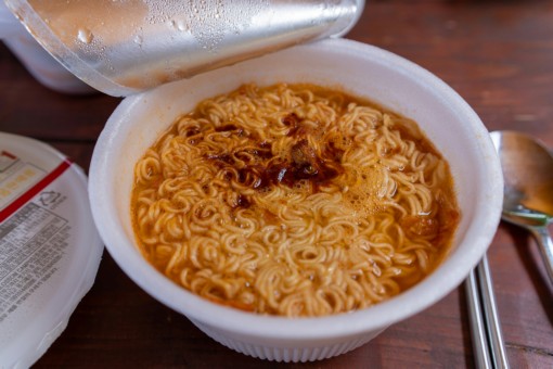 A cup of instant ramen noodles.
