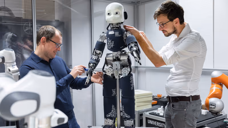 Two researchers are working on their robot