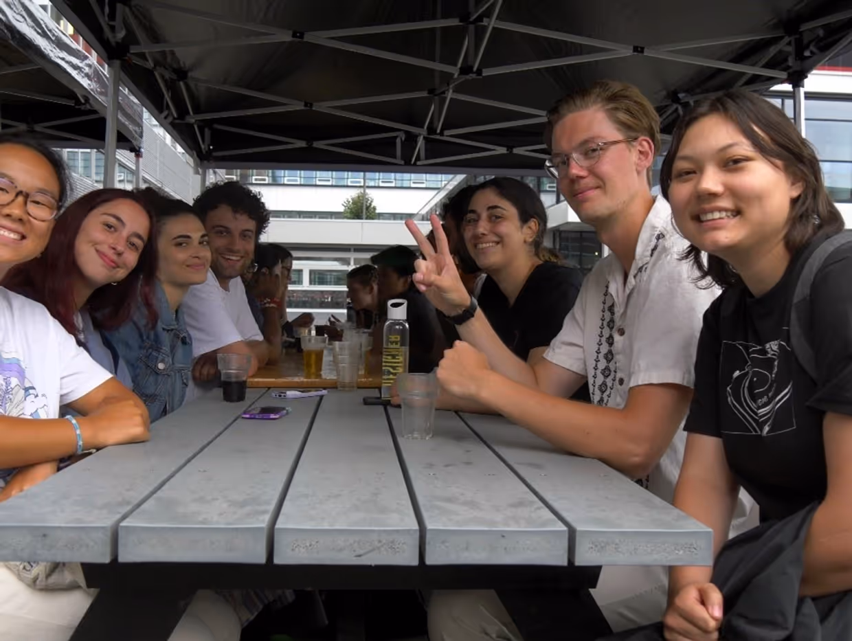 a group of people sitting at a picknick table