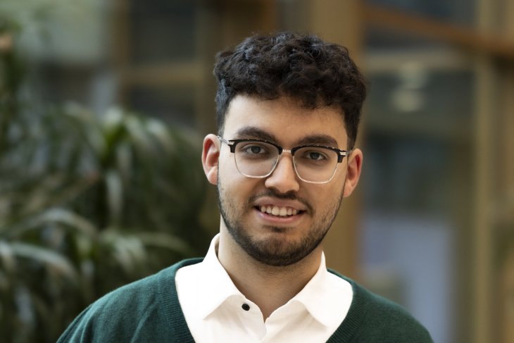 Student Business Administration Kadhem smiles into the camera.