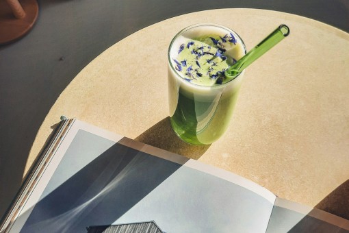 A café setting with a matcha drink and a book.