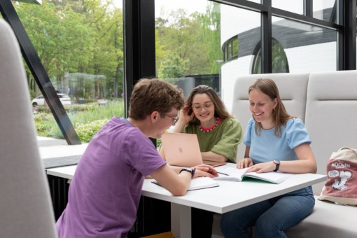 Three students working on a project together.