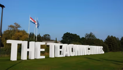 concrete letters spelling out "The Teaching Times"