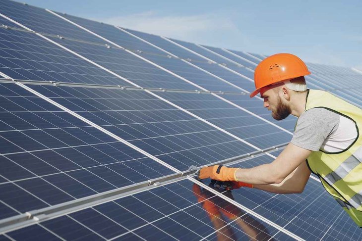 Professional installer installing a solar panel