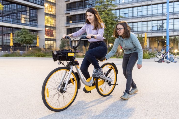 A student learning how to bike