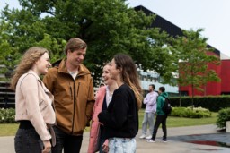A group of students talking and laughing.