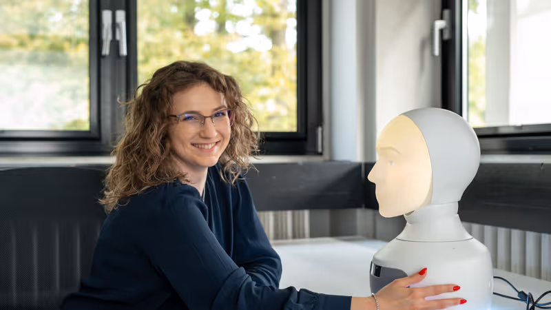 Lab employee working with Furhat.