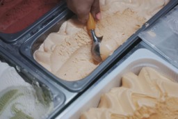 A student scooping ice cream on their summer job.