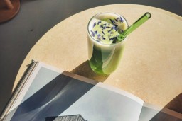 A café setting with a matcha drink and a book.
