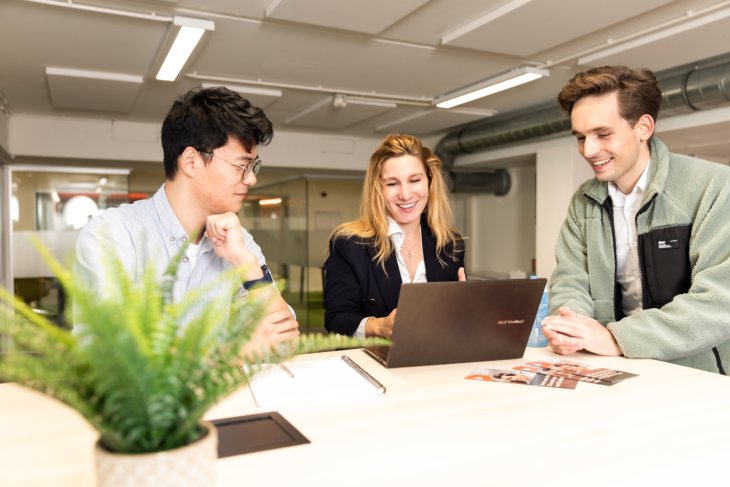 Three students working on a project on the campus of the University of Twente.