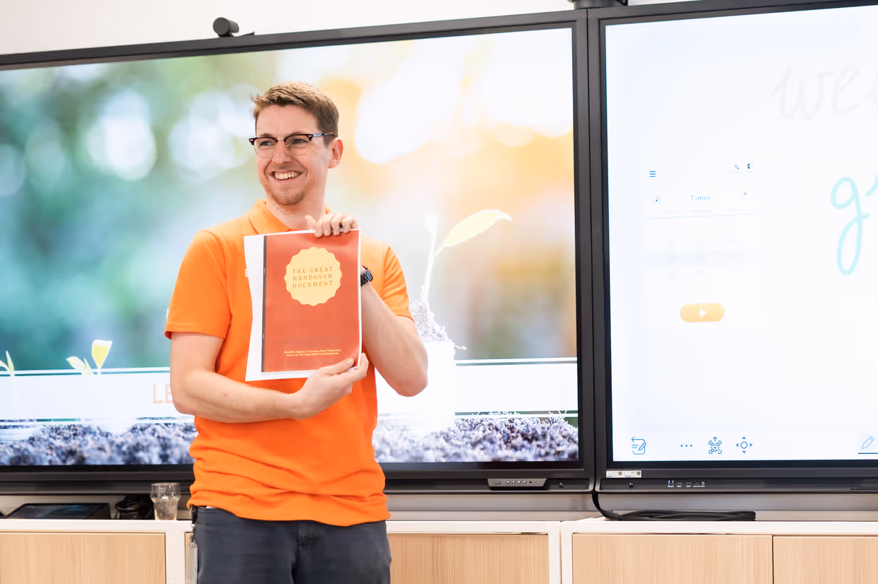 person holding a document saying "the great handover document"