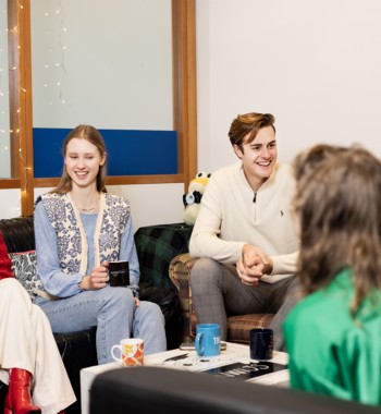 A group of students sitting on couches and talking.