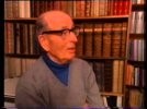 A person in glasses in front of a bookshelf

Description automatically generated
