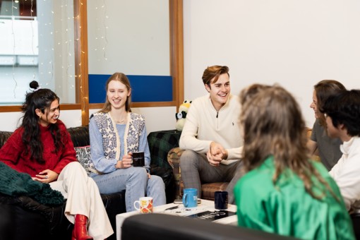 A group of students sitting on couches and talking.