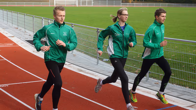 Three runners on the running track